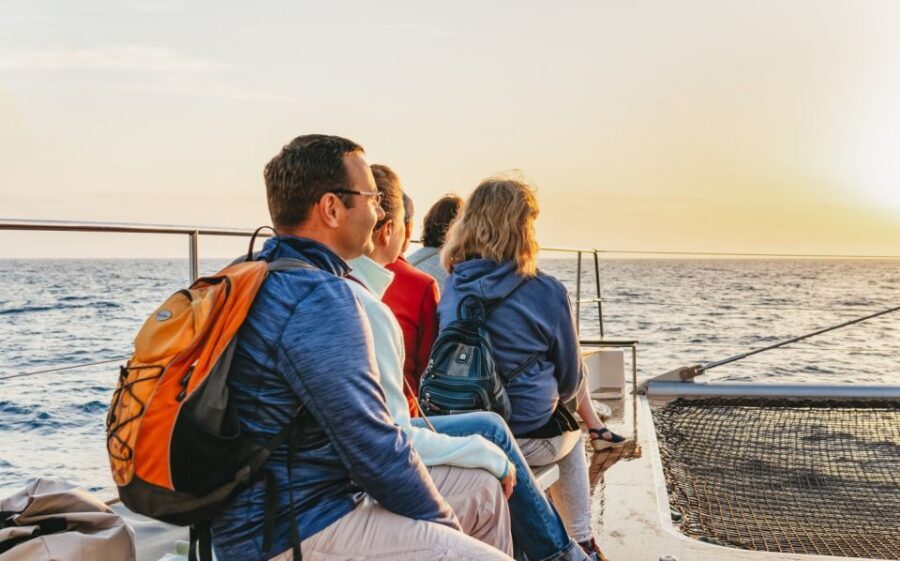 Alcudia: Sunset Catamaran Tour with Dinner and Snorkeling - On-deck vibe: music, dancing, and an onboard bar