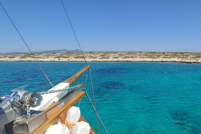Antiparos & Despotiko Kaiki Cruise — Coves, Swim & BBQ - Antiparos coast and the Mastihari Cave vibe: rocks, color, and a cave network