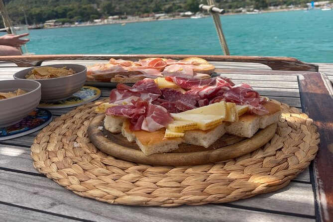 Cagliari Gulf Boat tour : 5 stops, snorkeling & local aperitif - SUP, music, and onboard comfort you’ll actually use