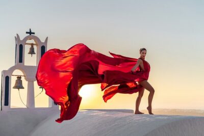 Flying Dress Photoshoot in Santorini by Flying Dress Photo © - Santorini Backdrops: Whitewashed Buildings, Churches, and Black Sand Possibilities