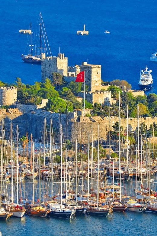From Kos: Oriental Bus Tour Bodrum w/Roundtrip Ferry&Pickup - Hotel pickup, passport control, and the 13 euro cash tax