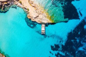 Ibiza: Beach Hopping Cruise w/ Paddleboard, Food, & Drinks - Cala Tarida Stop and the Coastline Views of Es Vedrà and Conejera