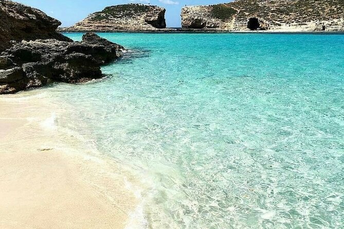 Malta Sunset Boat Tour: Bugibba to Comino Blue Lagoon Cruise - Onboard fun: bar, food, and the included 10m slide