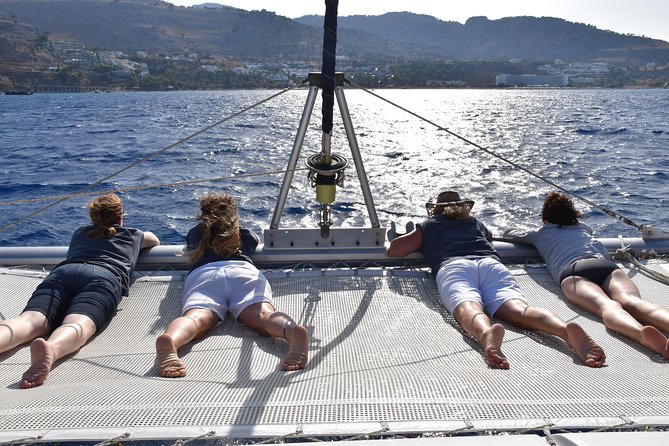 Private CATAMARAN daytrip - Lindos/ Rhodos with Lunch and drinks - Onboard comfort: restroom, loungers, and crew energy