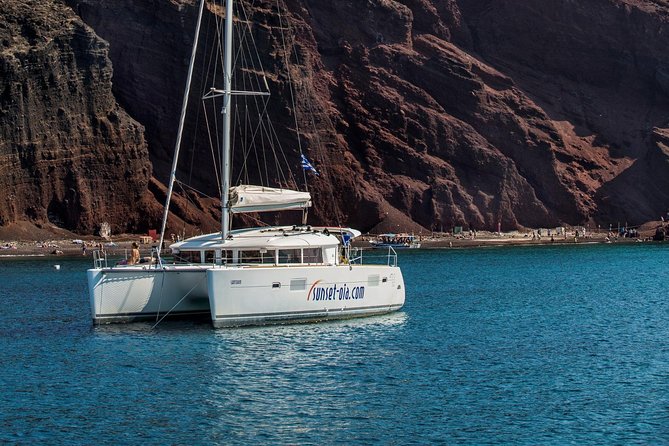 Private Morning Tour Lagoon 400-380 Sailing in Santorini ,lunch, drink, transfer - Red Beach (About 30 Minutes): Quick Views, Quick Swim, Fast Photos