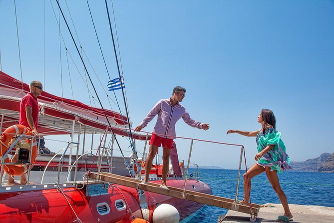 Sailing Catamaran Cruise in Santorini with BBQ, Drinks and Transfer - Red Beach and the color story: swim, snorkel, and move fast