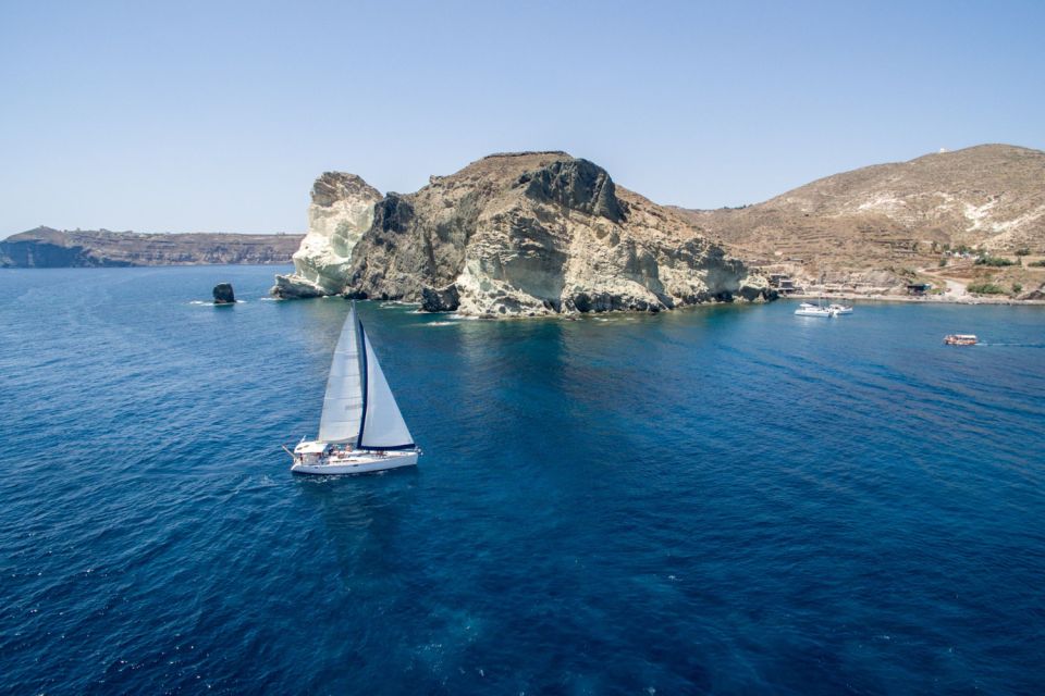 Santorini Caldera: Sunset Sailing Cruise with Meal - The first big wow: Red Beach and White Beach (short stops, good payoff)