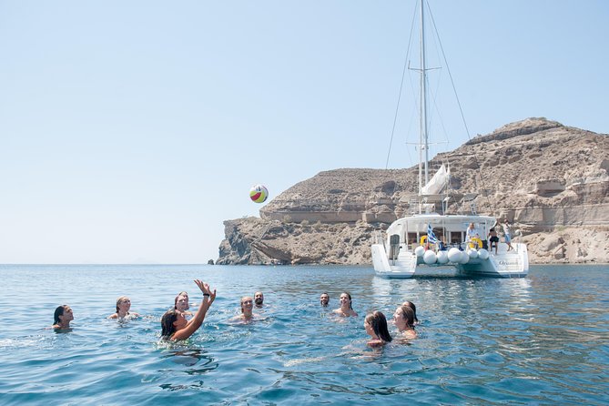 Santorini Catamaran Cruise with Fresh Meal and Open Bar - Akrotiri’s lighthouse, Indian Rock, and the famous cliff profile from the sea