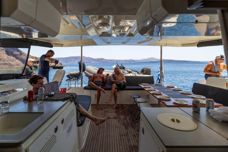 Santorini: Catamaran Cruise with Fresh Meal & Open Bar - The Akrotiri Lighthouse moment: Santorini’s southern end from the water