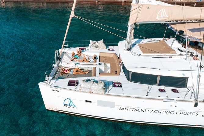 Santorini Catamaran Cruise: with Lunch, BBQ, Open Bar, Transfers - Sailing highlights: White Beach, Indian Rocks, and the Venetian Lighthouse