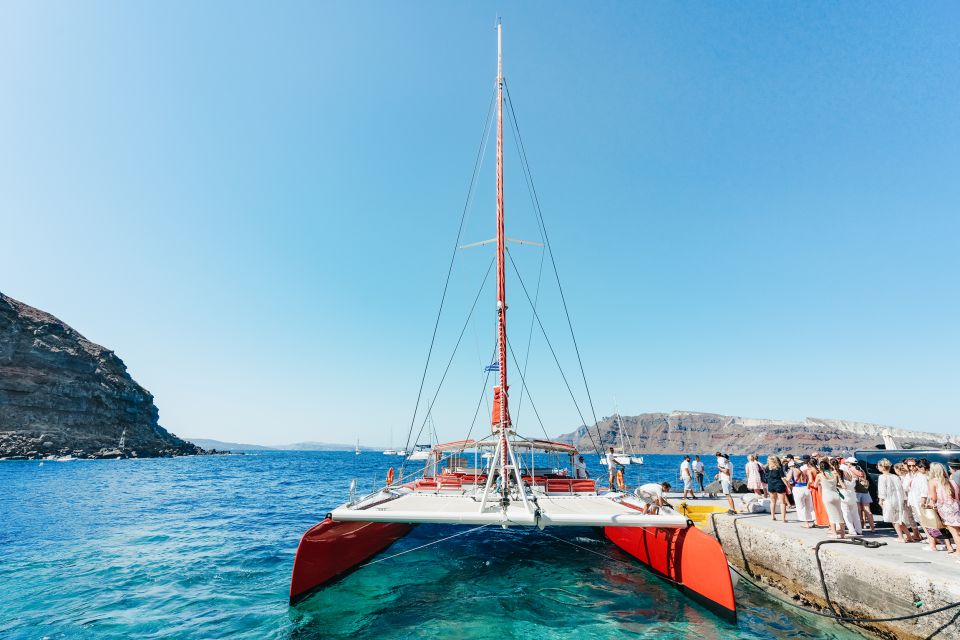 Santorini: Catamaran Tour with BBQ Dinner, Drinks, and Music - The 5-hour flow: hot springs, Red Beach, White Beach, then caldera time