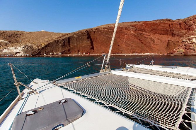 Santorini Half Day Catamaran Private Cruise incl. Meal, Drinks & Free Transport - Red Beach and White Beach: volcanic color, plus snorkeling without the land scramble