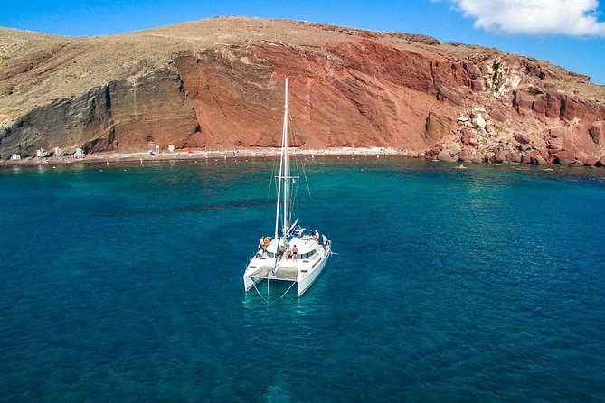 Santorini Half Day Catamaran Private Cruise incl. Meal, Drinks & Free Transport - Vlyhada port and marina: where the day starts on black sand