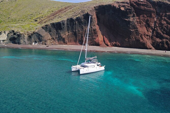 Santorini: Luxury Catamaran Cruise with Fresh Fish BBQ & Drinks - South Coast Views: Lighthouse Moments and Caldera Drama