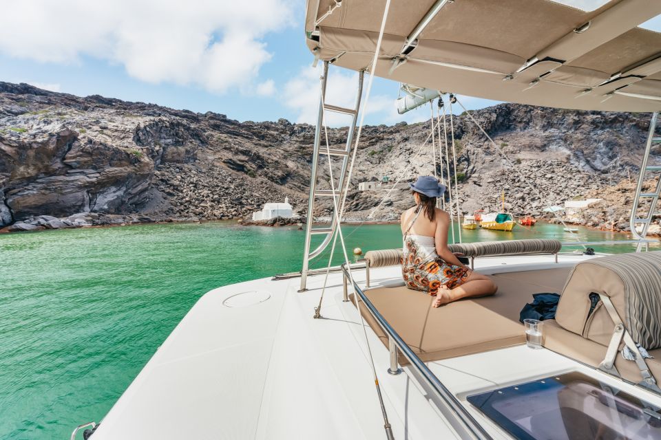 Santorini: Luxury Catamaran Day Trip with Meal and Open Bar - What to bring (and what the boat already provides)