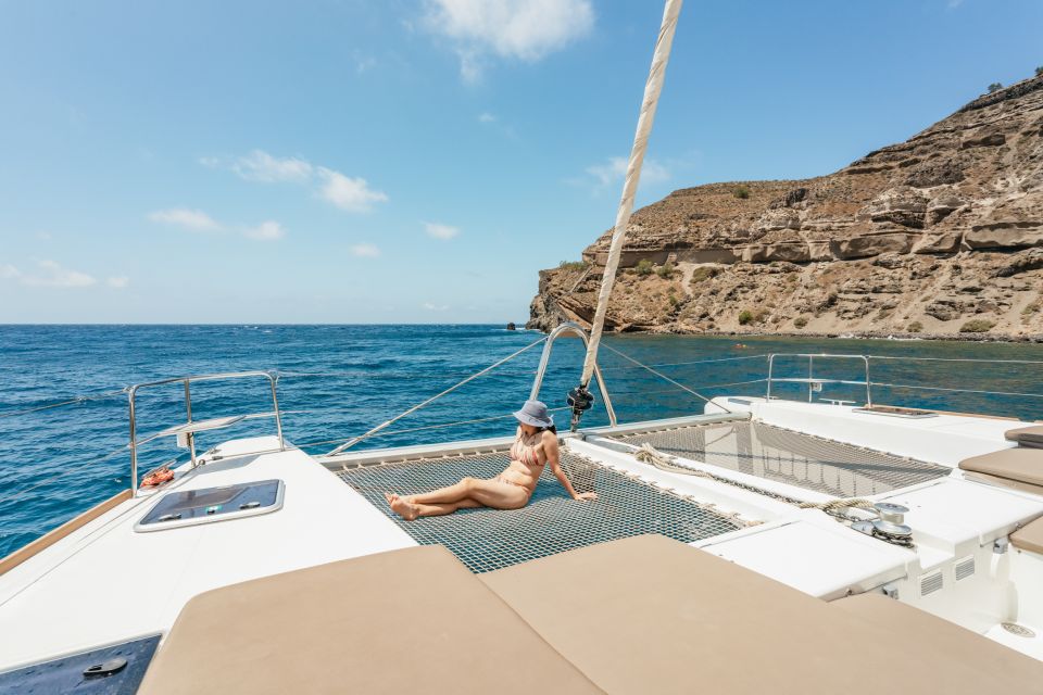 Santorini: Luxury Catamaran Day Trip with Meal and Open Bar - Red Beach coastline stop: the first taste of the caldera on open water