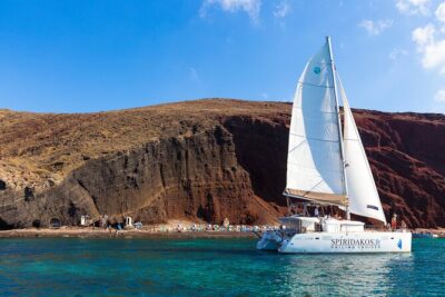 Santorini Private Catamaran Cruise with BBQ, Open Bar & Transfers - Red Beach at Akrotiri: The Iron-Rich Color Stop