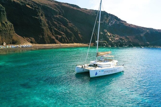 Santorini Private Catamaran Cruise with BBQ, Open Bar & Transfers - Sailing Past Thirasia and Nea Kameni Views From Sea Level