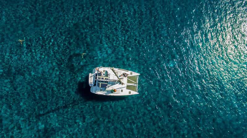 Santorini: Private Catamaran Cruise with Food & Drinks - The Caldera sightseeing loop: Red Beach, White Beach, and lighthouse views