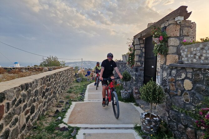 Santorini Small Group Guided E-bike Tour & Local Tomato Museum - Perissa Black Sand Beach: a quick jolt of contrast
