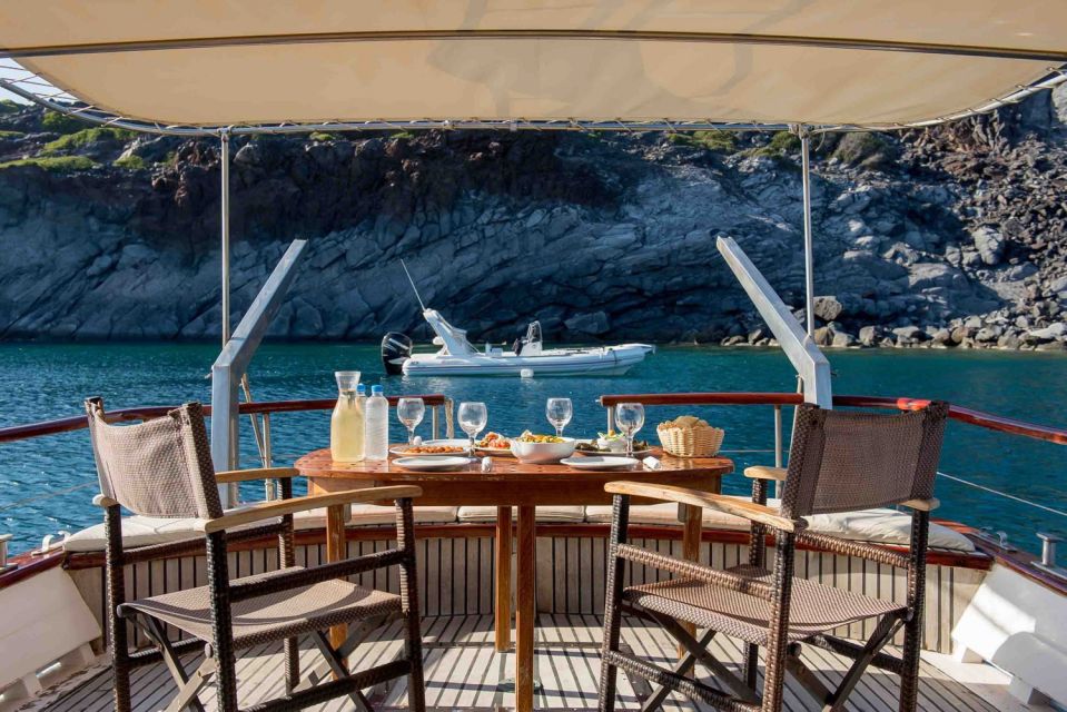 Santorini: Traditional Wooden Boat Tour with Meal and Wine - Akrotiri Lighthouse: Scenic Passing Plus Caldera Context