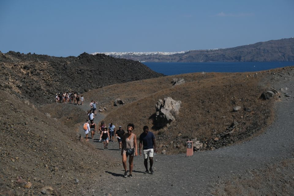 Santorini: Volcano and Hot Springs Sunset Dinner Cruise - Nea Kameni Volcano Hike: Steep stairs over real volcanic ground